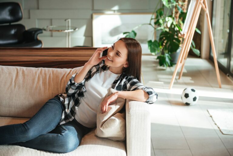 woman-smiling-and-talking-on-phone-PPFN8JM